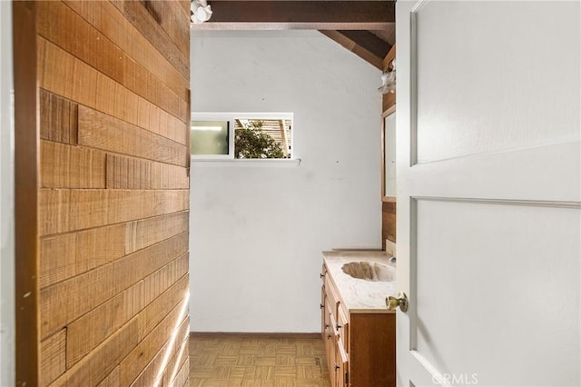 950 N Laurel Dr, Orange, CA 92867 - bathroom with vanity, wooden walls, beam ceiling, and baseboards