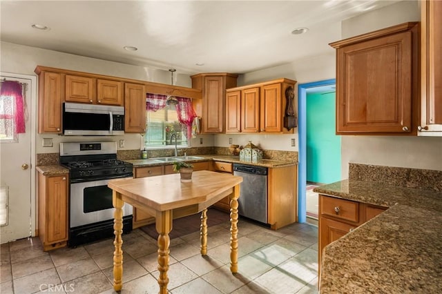 950 N Laurel Dr, Orange, CA 92867 - kitchen with stainless steel appliances, a sink, light tile patterned flooring, brown cabinetry, and recessed lighting