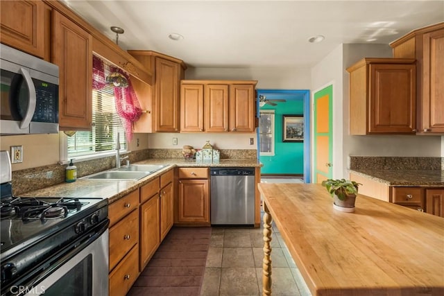 950 N Laurel Dr, Orange, CA 92867 - kitchen featuring stainless steel appliances, wood counters, a sink, a ceiling fan, and recessed lighting