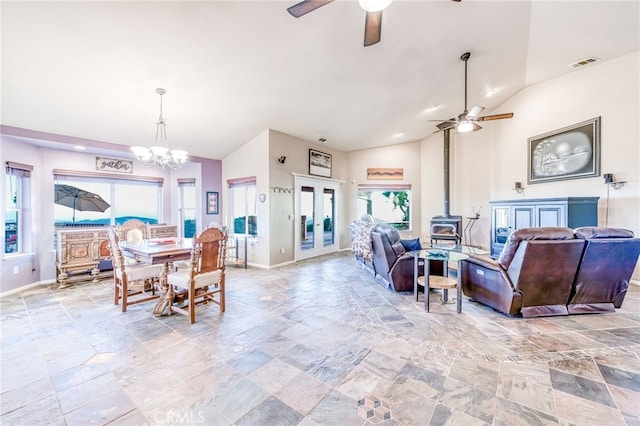 50806 Bramble Ln, Squaw Valley, CA 93675 - dining area featuring stone tile floors, lofted ceiling, ceiling fan, french doors, and a wood stove