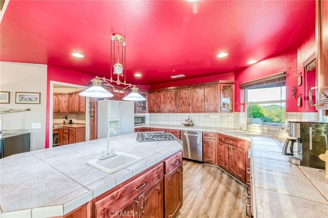 50806 Bramble Ln, Squaw Valley, CA 93675 - kitchen featuring stainless steel appliances, tile countertops, recessed lighting, decorative backsplash, and light wood-type flooring
