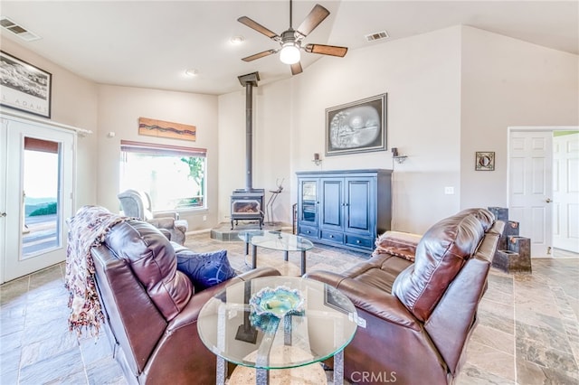 50806 Bramble Ln, Squaw Valley, CA 93675 - living area featuring a wood stove, ceiling fan, and light stone finish flooring