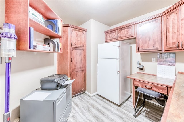 50806 Bramble Ln, Squaw Valley, CA 93675 - kitchen with freestanding refrigerator, light wood-style floors, a desk, light countertops, and open shelves