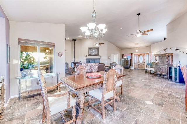 50806 Bramble Ln, Squaw Valley, CA 93675 - dining room featuring a ceiling fan, a wood stove, light stone finish flooring, healthy amount of natural light, and lofted ceiling