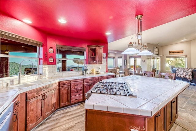 50806 Bramble Ln, Squaw Valley, CA 93675 - kitchen featuring tile counters, open floor plan, decorative backsplash, a center island, and recessed lighting
