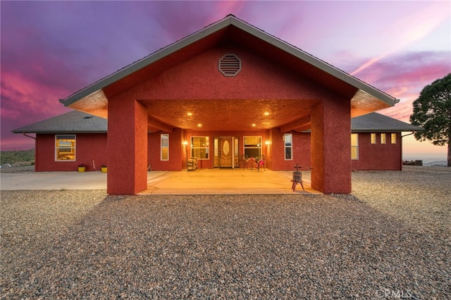 50806 Bramble Ln, Squaw Valley, CA 93675 - back of house at dusk with stucco siding and covered porch