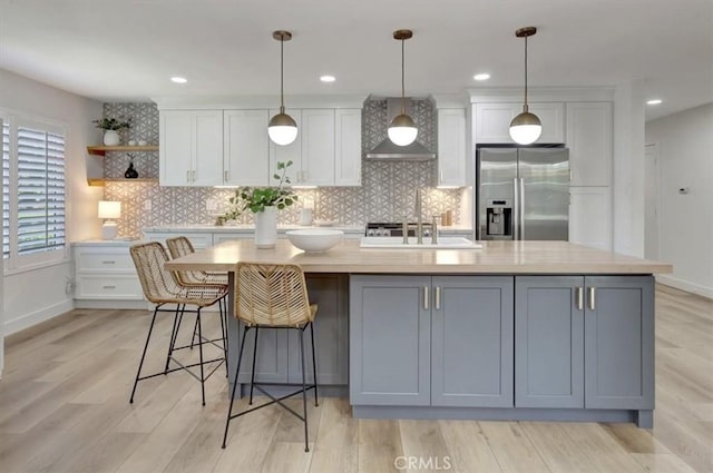 27865 Espinoza, Mission Viejo, CA 92692 - kitchen with stainless steel refrigerator with ice dispenser, wall chimney exhaust hood, a sink, white cabinetry, and light countertops