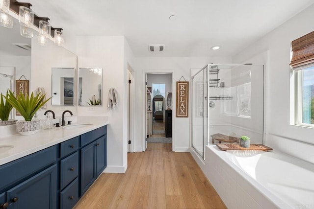 25444 Red Hawk Rd, Corona, CA 92883 - bathroom with double vanity, wood finished floors, a garden tub, a shower stall, and recessed lighting