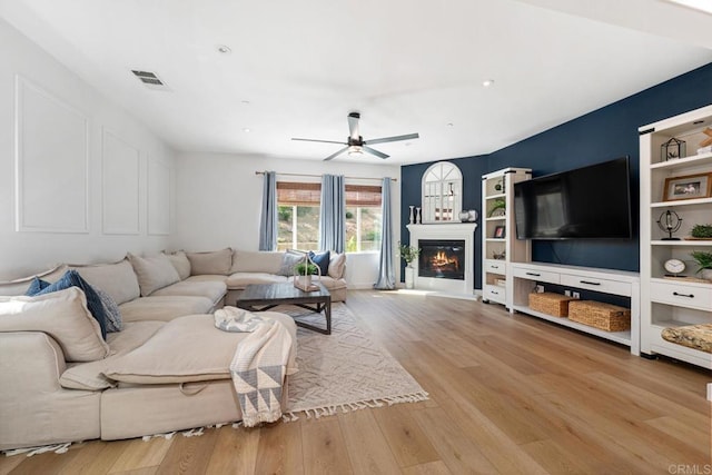 25444 Red Hawk Rd, Corona, CA 92883 - living area with wood finished floors, a ceiling fan, and a glass covered fireplace