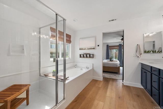 25444 Red Hawk Rd, Corona, CA 92883 - ensuite bathroom with vanity, a garden tub, a stall shower, wood finished floors, and a ceiling fan