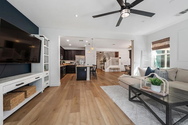 25444 Red Hawk Rd, Corona, CA 92883 - living room with stairs, a ceiling fan, light wood-type flooring, and recessed lighting