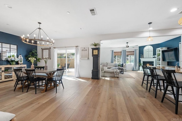 25444 Red Hawk Rd, Corona, CA 92883 - dining room featuring a lit fireplace, light wood-style flooring, a ceiling fan, plenty of natural light, and recessed lighting