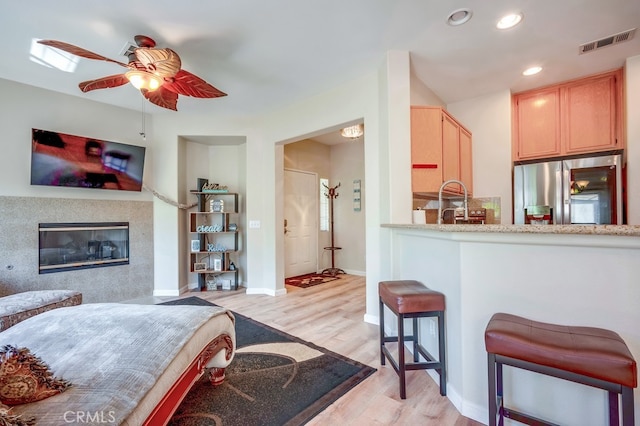 39723 Columbia Union Dr Unit A, Murrieta, CA 92563 - kitchen featuring stainless steel refrigerator with ice dispenser, ceiling fan, light wood finished floors, light brown cabinetry, and recessed lighting