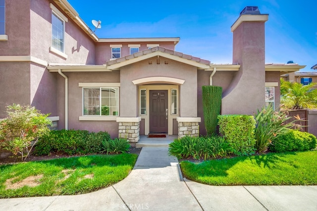 39723 Columbia Union Dr Unit A, Murrieta, CA 92563 - view of front facade with stucco siding, stone siding, and a chimney