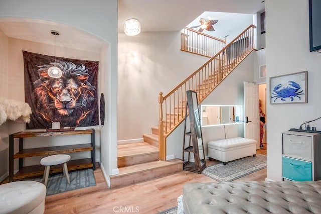 39723 Columbia Union Dr Unit A, Murrieta, CA 92563 - stairs with wood finished floors, arched walkways, and baseboards