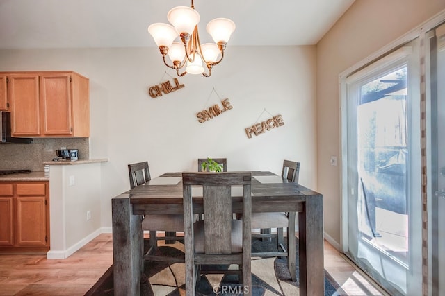 39723 Columbia Union Dr Unit A, Murrieta, CA 92563 - dining space featuring light wood finished floors, a chandelier, and baseboards