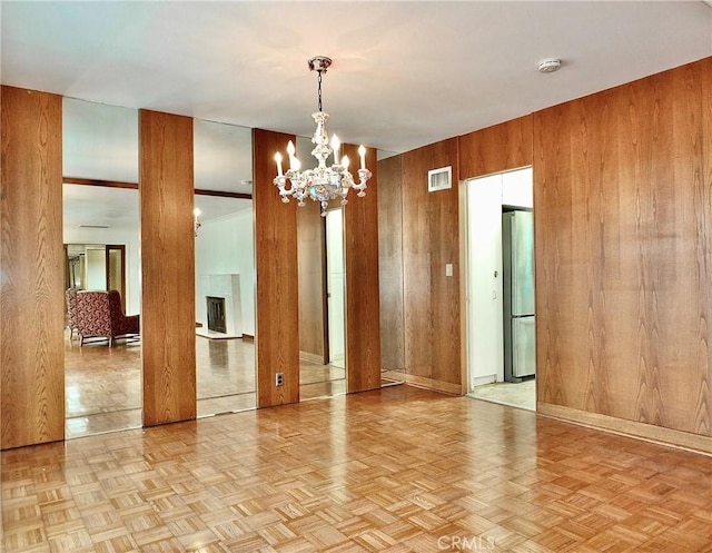 5510 E La Pasada St E, Long Beach, CA 90815 - empty room with wood walls, a chandelier, and a smoke detector