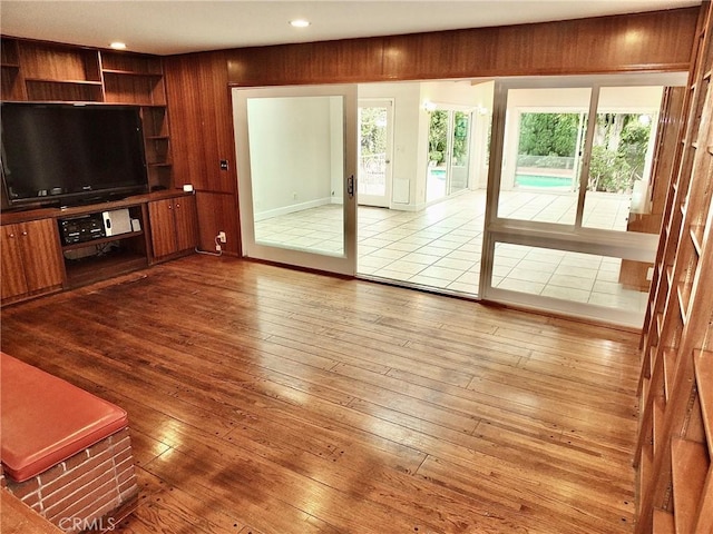 5510 E La Pasada St E, Long Beach, CA 90815 - unfurnished living room with hardwood / wood-style floors, recessed lighting, and wood walls