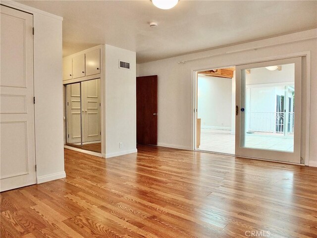 5510 E La Pasada St E, Long Beach, CA 90815 - empty room featuring light wood finished floors, baseboards, and a smoke detector