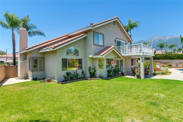 6909 Stanislaus Pl, Rancho Cucamonga, CA 91701 - back of property with a tiled roof, a chimney, stucco siding, a patio area, and a mountain view