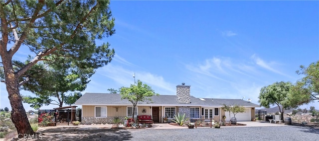 40125 Scanlon Rd, Temecula, CA 92592 - single story home featuring an attached garage, concrete driveway, a chimney, and stone siding