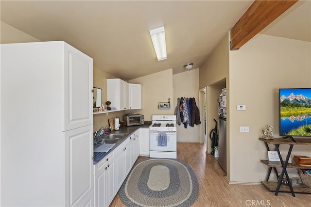 40125 Scanlon Rd, Temecula, CA 92592 - kitchen featuring white range with gas cooktop, a sink, light wood-style flooring, dark countertops, and white cabinets