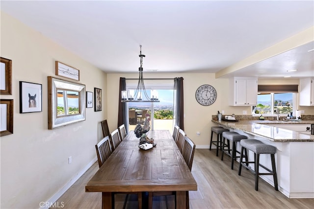 40125 Scanlon Rd, Temecula, CA 92592 - dining area with healthy amount of natural light, a chandelier, baseboards, and light wood-style flooring