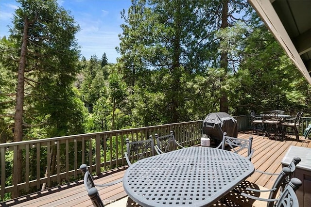 24755 Basel Dr, Crestline, CA 92325 - wooden terrace with outdoor dining space and a grill