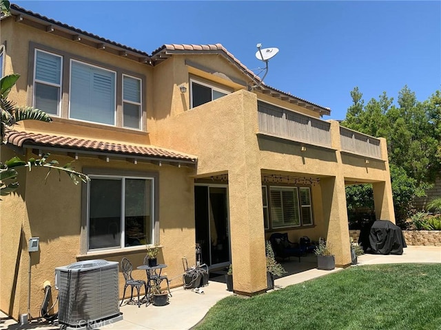 28626 Stonegate Ct, Valencia, CA 91354 - back of property featuring central AC, a balcony, a tile roof, a patio area, and stucco siding