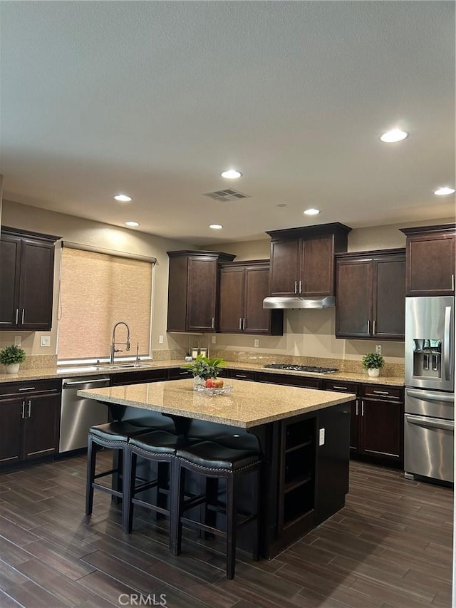 28626 Stonegate Ct, Valencia, CA 91354 - kitchen featuring stainless steel appliances, a center island, dark wood finished floors, dark brown cabinets, and recessed lighting