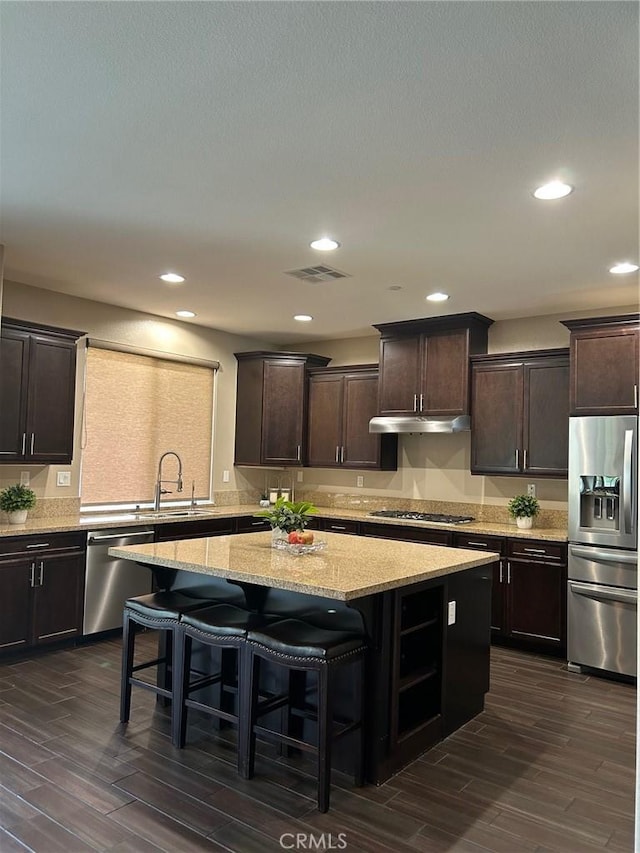 28626 Stonegate Ct, Valencia, CA 91354 - kitchen featuring appliances with stainless steel finishes, a center island, dark wood-style floors, dark brown cabinets, and recessed lighting