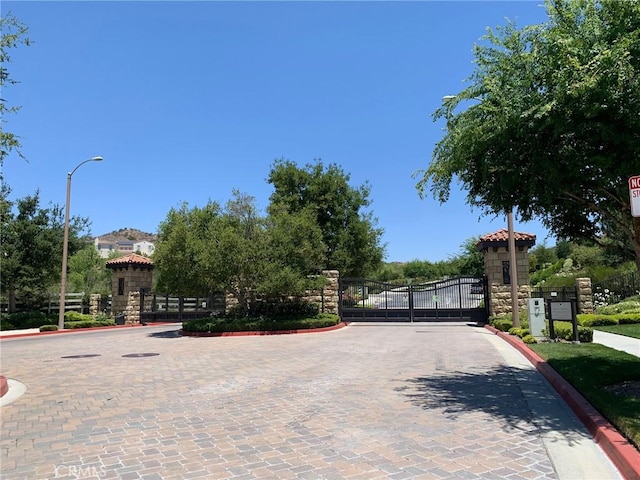 28626 Stonegate Ct, Valencia, CA 91354 - view of street with curbs, a gate, a gated entry, and street lights