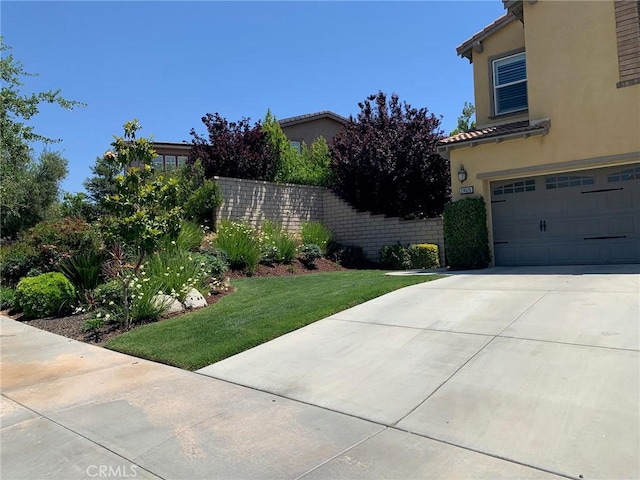 28626 Stonegate Ct, Valencia, CA 91354 - view of yard with a garage and concrete driveway