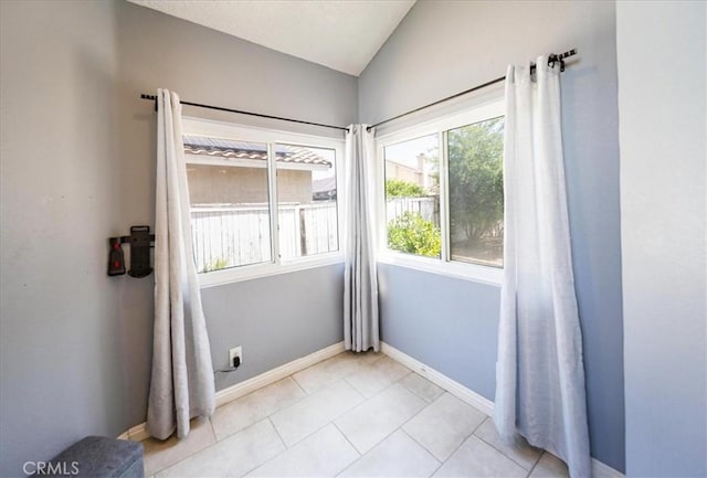 29870 Corte Cruzada, Menifee, CA 92584 - empty room with vaulted ceiling, baseboards, and light tile patterned floors