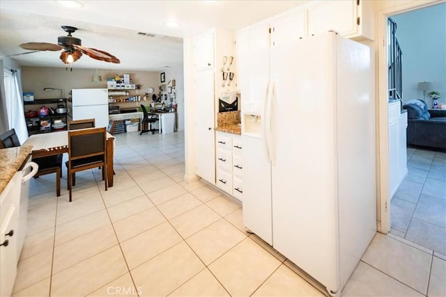 29870 Corte Cruzada, Menifee, CA 92584 - kitchen featuring white fridge with ice dispenser, a ceiling fan, light tile patterned floors, freestanding refrigerator, and white cabinetry