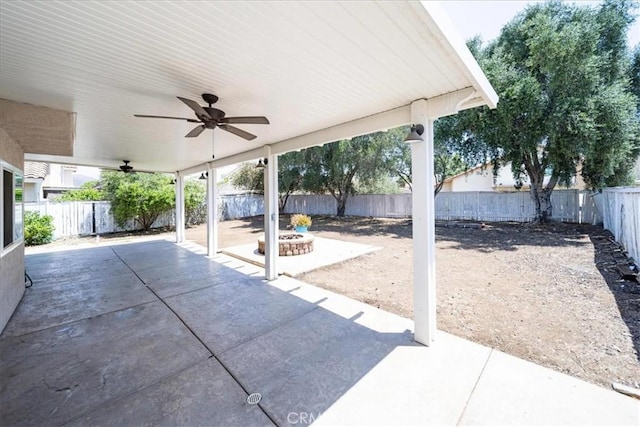 29870 Corte Cruzada, Menifee, CA 92584 - fenced backyard with a patio area, ceiling fan, and a fire pit