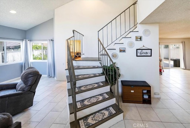 29870 Corte Cruzada, Menifee, CA 92584 - stairway with a textured ceiling, tile patterned floors, lofted ceiling, and baseboards