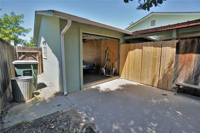 2306 S Encina St, Visalia, CA 93277 - view of side of home featuring an attached garage, concrete driveway, a patio, and stucco siding