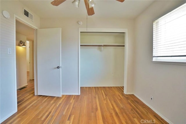 2306 S Encina St, Visalia, CA 93277 - unfurnished bedroom featuring a closet, wood finished floors, and a ceiling fan