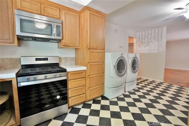 2306 S Encina St, Visalia, CA 93277 - kitchen with stainless steel appliances, separate washer and dryer, tile patterned floors, and tile countertops