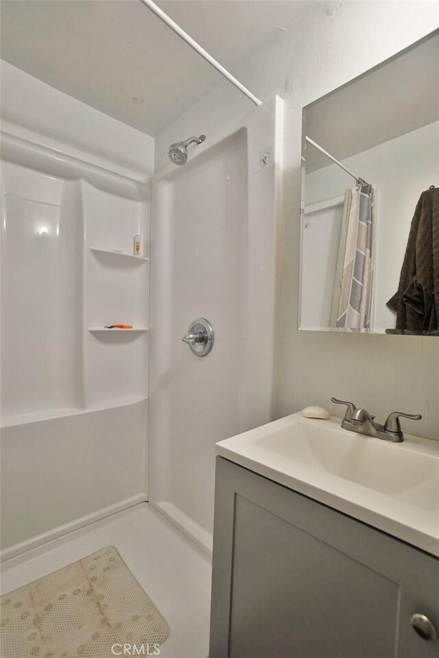 2306 S Encina St, Visalia, CA 93277 - bathroom with vanity and a shower with shower curtain