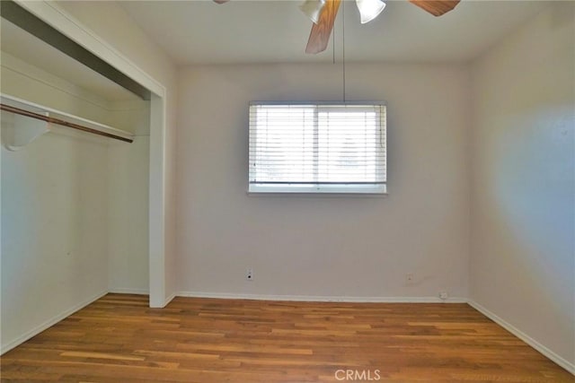 2306 S Encina St, Visalia, CA 93277 - unfurnished bedroom featuring wood finished floors, baseboards, a closet, and a ceiling fan