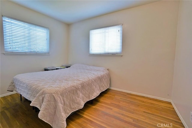 2306 S Encina St, Visalia, CA 93277 - bedroom with multiple windows, wood finished floors, and baseboards