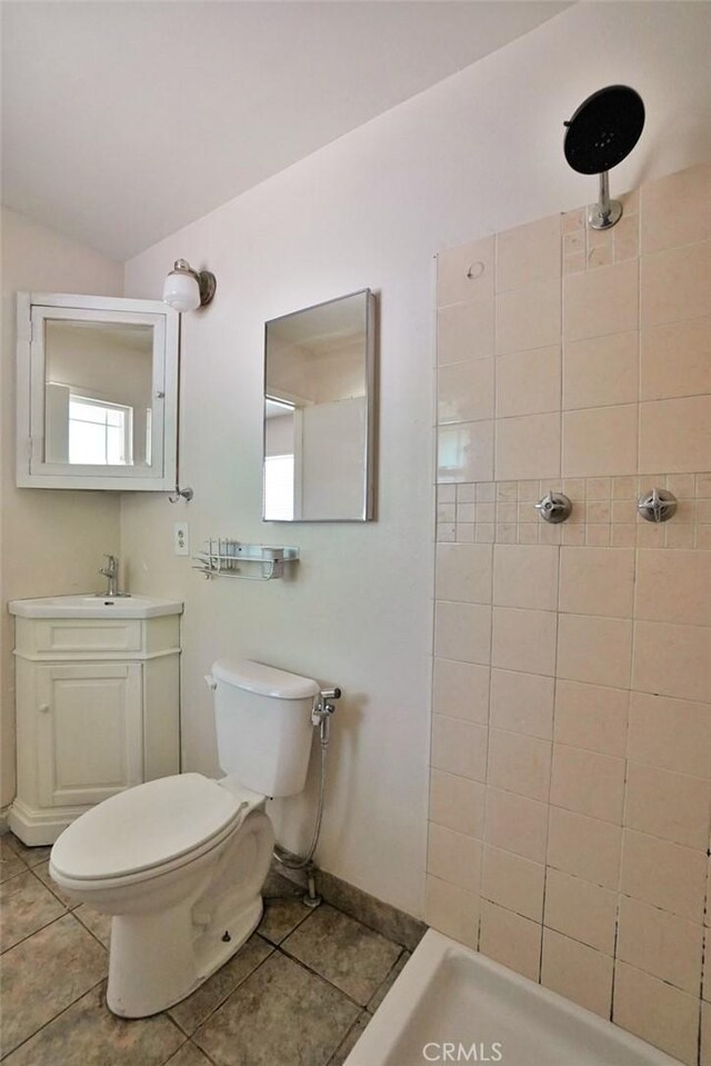 2306 S Encina St, Visalia, CA 93277 - bathroom with tile patterned flooring, tiled shower, vanity, baseboards, and vaulted ceiling
