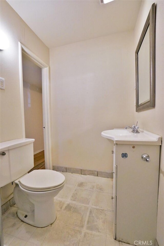 2306 S Encina St, Visalia, CA 93277 - bathroom featuring toilet, vanity, and baseboards