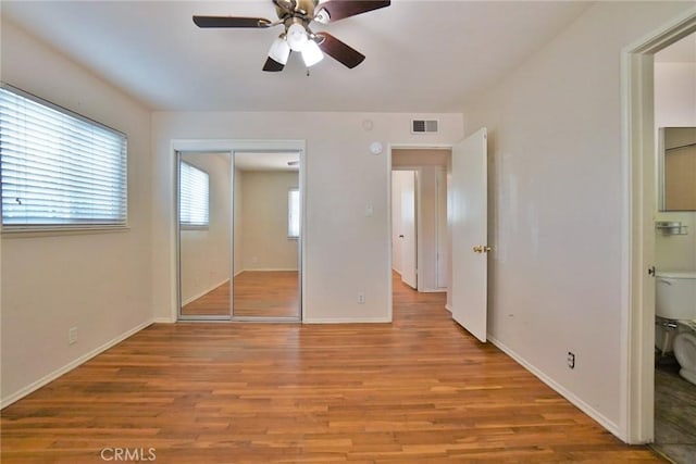 2306 S Encina St, Visalia, CA 93277 - unfurnished bedroom featuring light wood finished floors, a closet, and baseboards