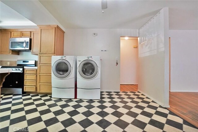 2306 S Encina St, Visalia, CA 93277 - washroom with washing machine and clothes dryer, light floors, and baseboards
