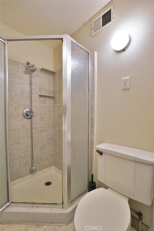 2306 S Encina St, Visalia, CA 93277 - full bathroom with a shower stall, toilet, and tile patterned flooring