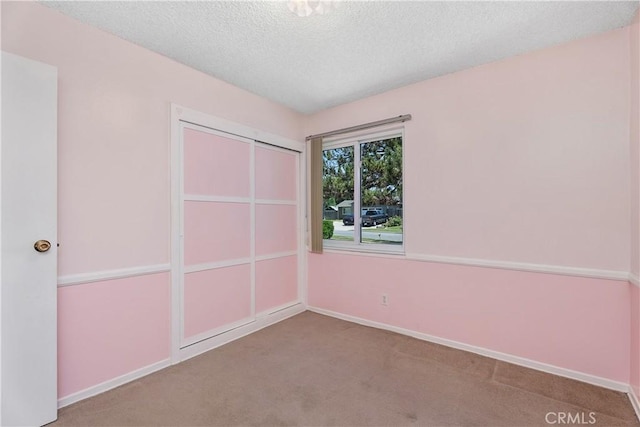 11747 Hollyview Dr, La Mirada, CA 90638 - unfurnished bedroom with carpet, a textured ceiling, a closet, and baseboards