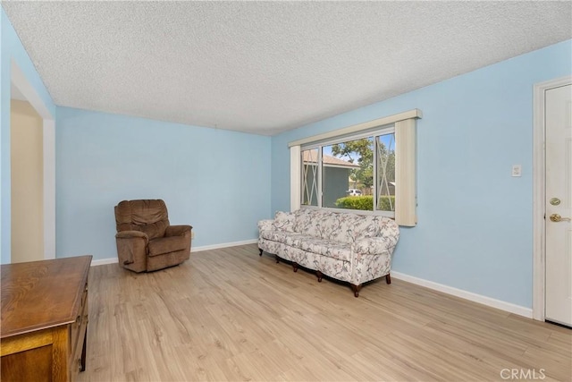11747 Hollyview Dr, La Mirada, CA 90638 - sitting room featuring light wood-type flooring, baseboards, and a textured ceiling